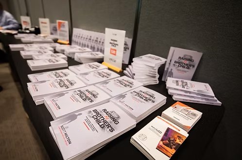 Stacks of Raising My Brother's Child on a launch event table